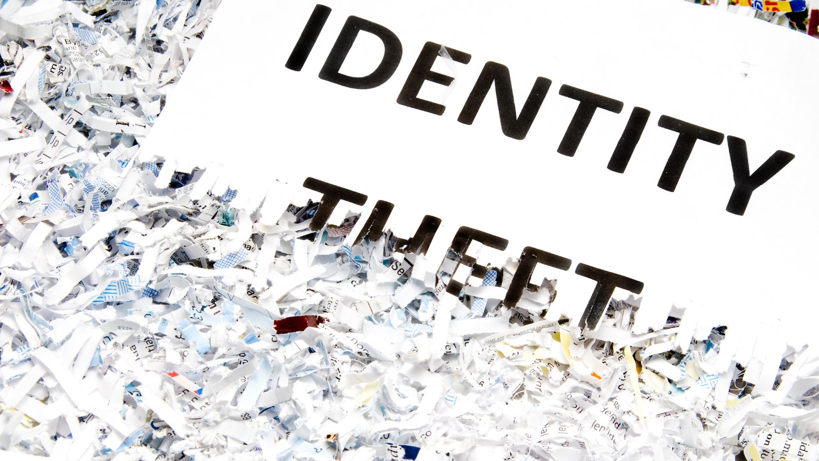 shredded paper surrounding the words "identity theft"