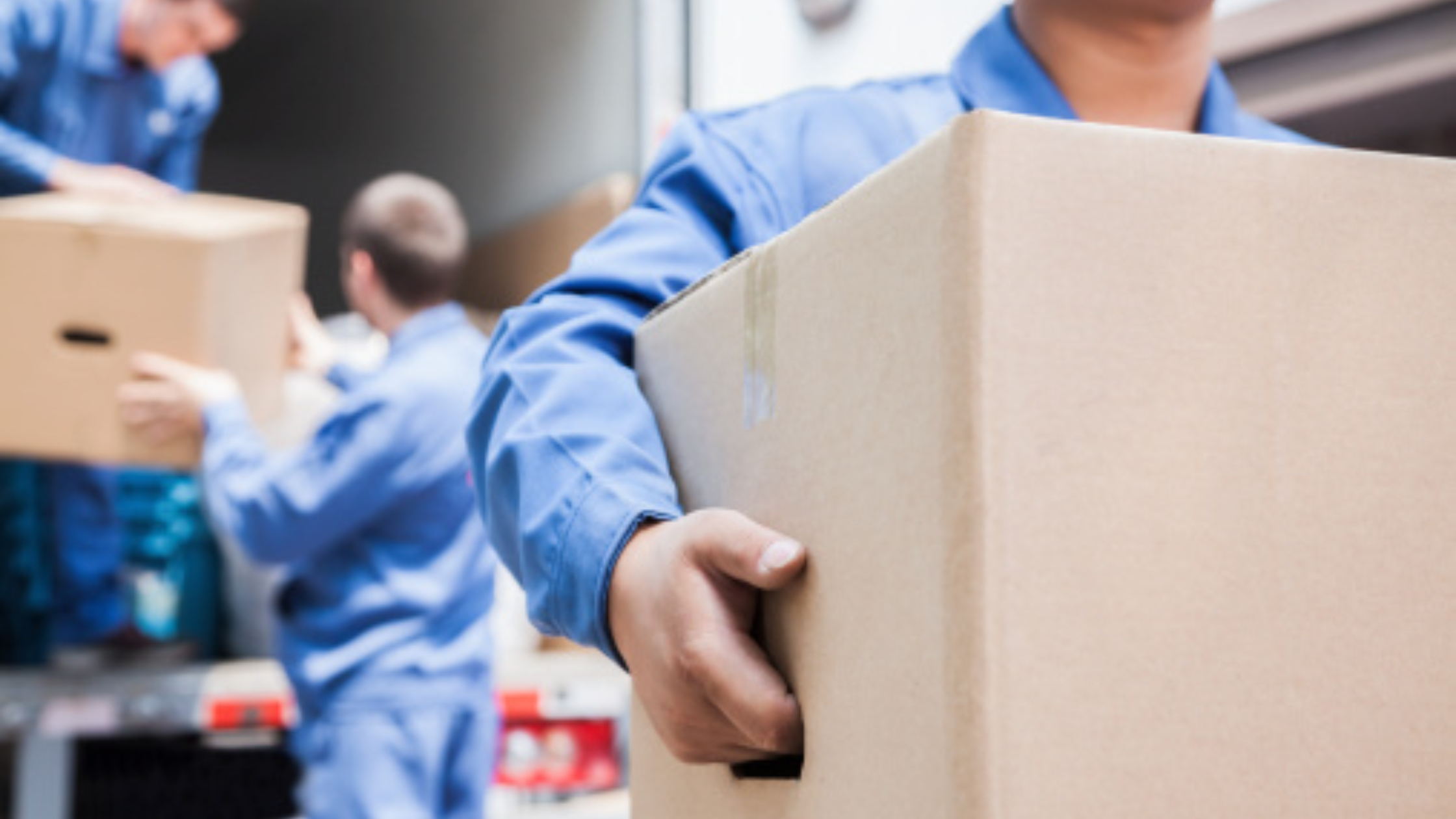 Employees carrying archive boxes for secure off-site document storage, illustrating professional records management, business document storage services, and the transfer of archived files to a secure storage facility.